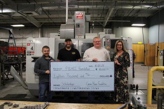 Instructors Denver Smith, Justin Durden, and Talmage Thomas receive a big check presented by Tiffani Underwood, P&HCC Foundation Executive Director.