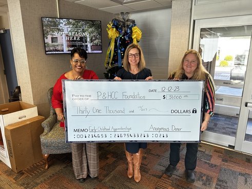 In the photo: P&HCC Foundation executive director Tiffani Underwood (center) presents grant funding to Rachel Hodge, transfer navigator, and Jan Harrison, faculty member