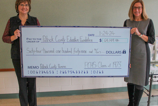 P&HCC Foundation executive director Tiffani Underwood (right) presents the PCHS Class of 1973 donation to Angie Brown, Patrick County site facilitator.