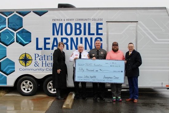 Shannon Whitlow, P&HCC director of workforce advising & coaching; Steve Draper, Martinsville City sheriff; Wayne Davis, Henry County sheriff; Tim Forbes, P&HCC industrial electronics technology instructor; and Dr. Greg Hodges, P&HCC president receive an a